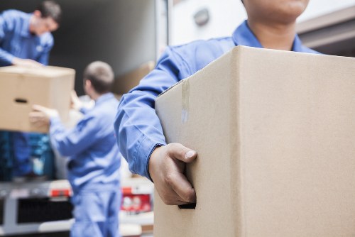 Removal team preparing household items for transport